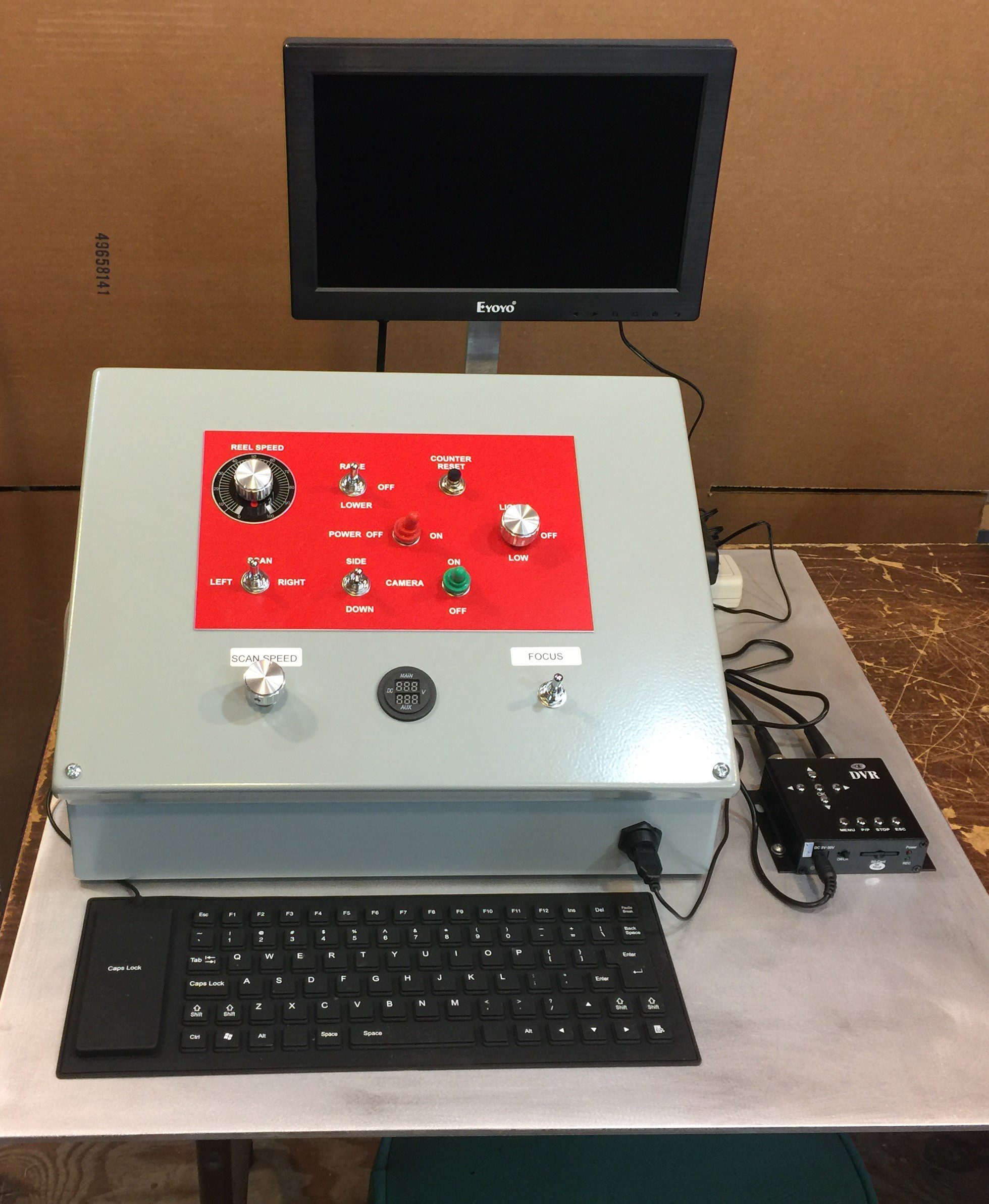 Control Panel With a Monitor and Keyboard on a Wooden Table